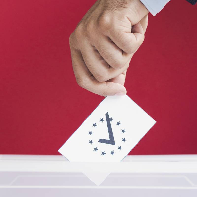 man putting his vote in ballot box